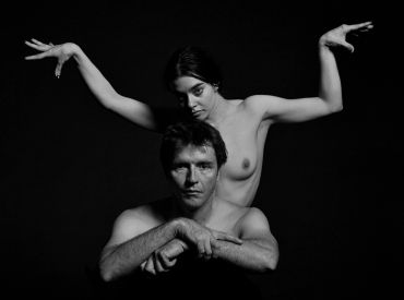 Black and white artistic portrait of a man and woman with expressive poses.