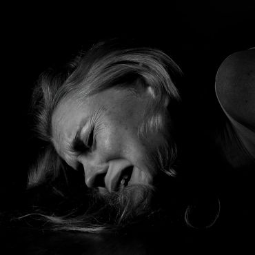 Black and white photo of a woman in distress, expressing deep emotion.