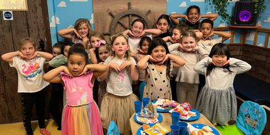 a group of children celebrate their friends birthday in kassiopi coves party room