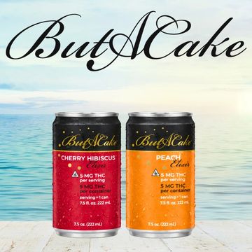 Two colorful ButACake THC-infused beverage cans by the ocean.