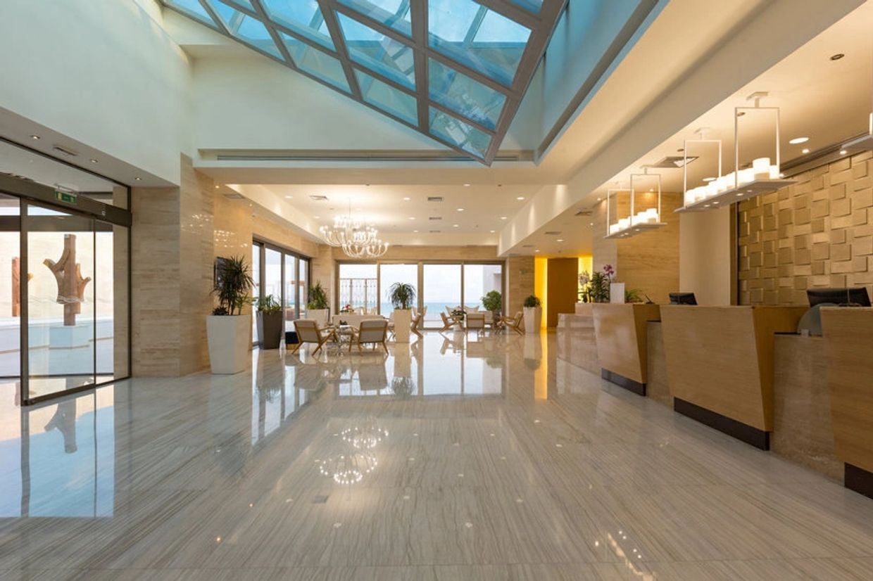 Spacious hotel lobby with modern decor and natural light.