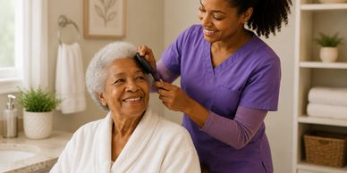 Caregiver gently combs elderly woman's hair, both smiling warmly.