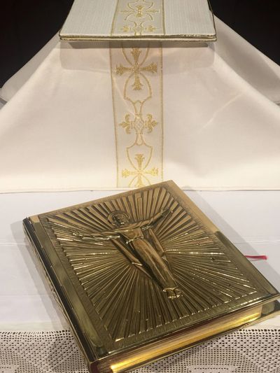 White Altar Stack with a Golden Gospel Book lying in front of it.