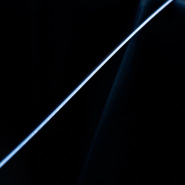 A thin, glowing blue line against a dark background.