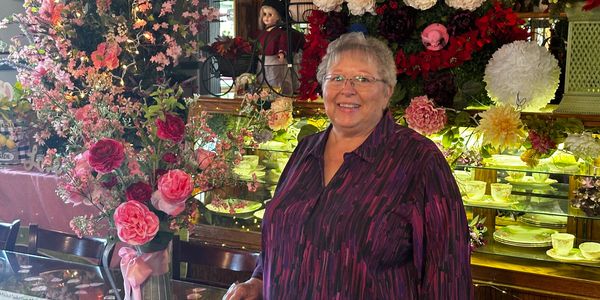 Colleen loves flowers and tea party sets shown in a tea shop in California