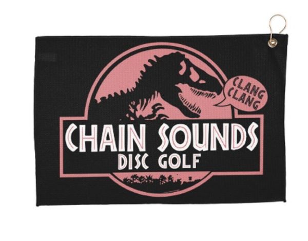 Black towel with dinosaur and text for Chain Sounds Disc Golf.