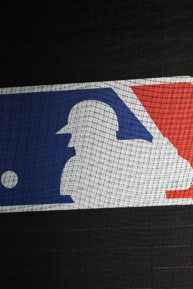 A striking image of the MLB logo set against a black backdrop