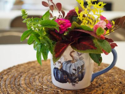 Colorful flowers in a decorated mug.