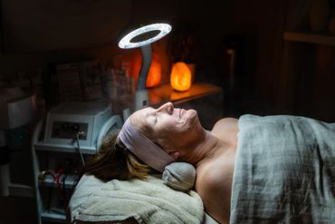 A facial treatment under a ring light