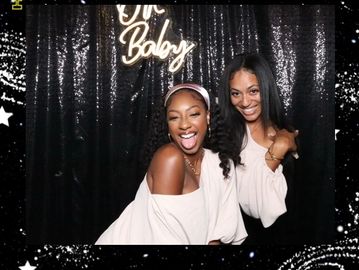 group of people smiling and enjoying photo booth 