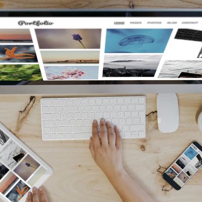 Person editing a photo portfolio on multiple devices.