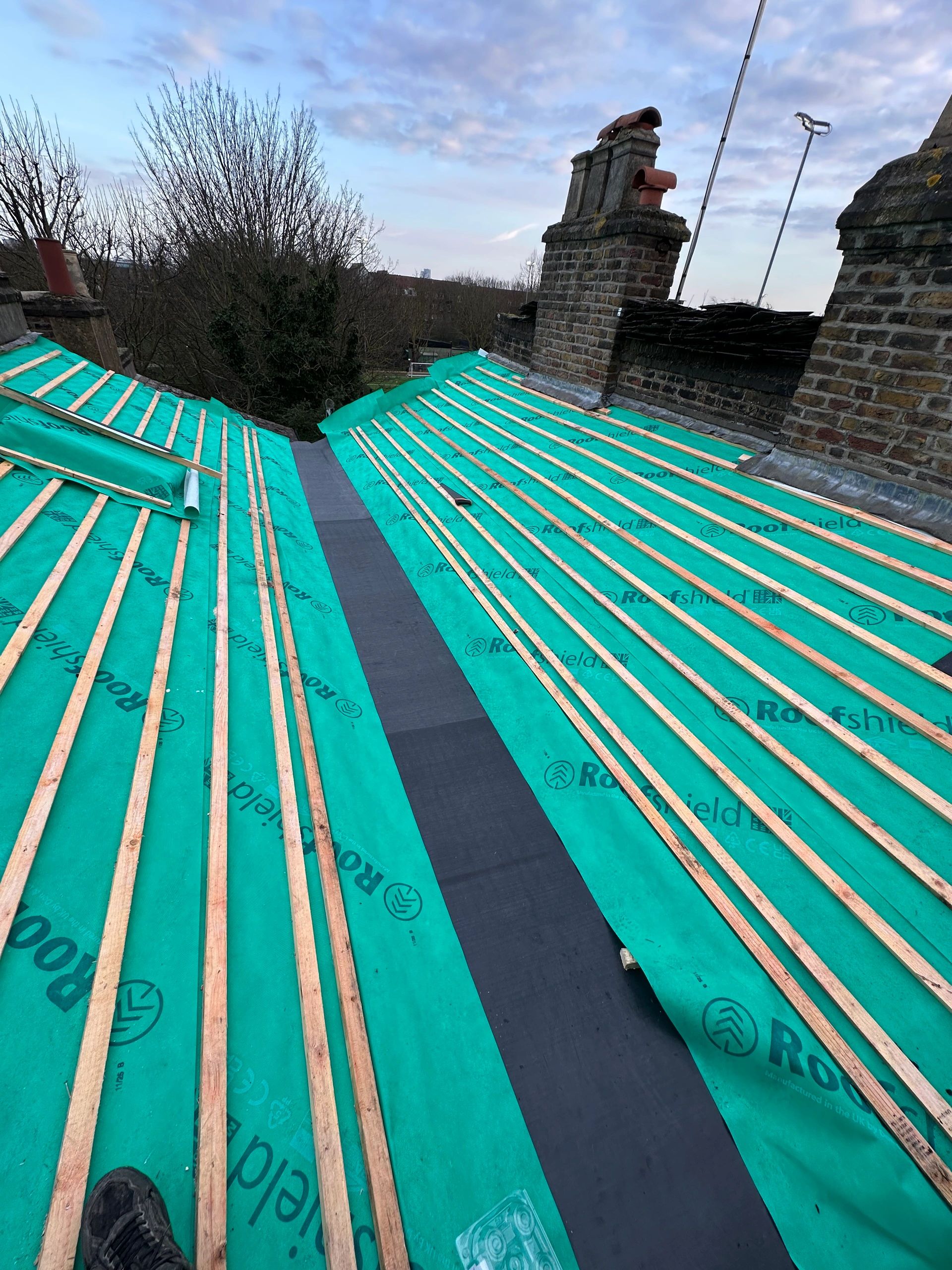Full roof refurbishment underway with new breathable membrane and treated battens installed, ready for the new roof covering.
