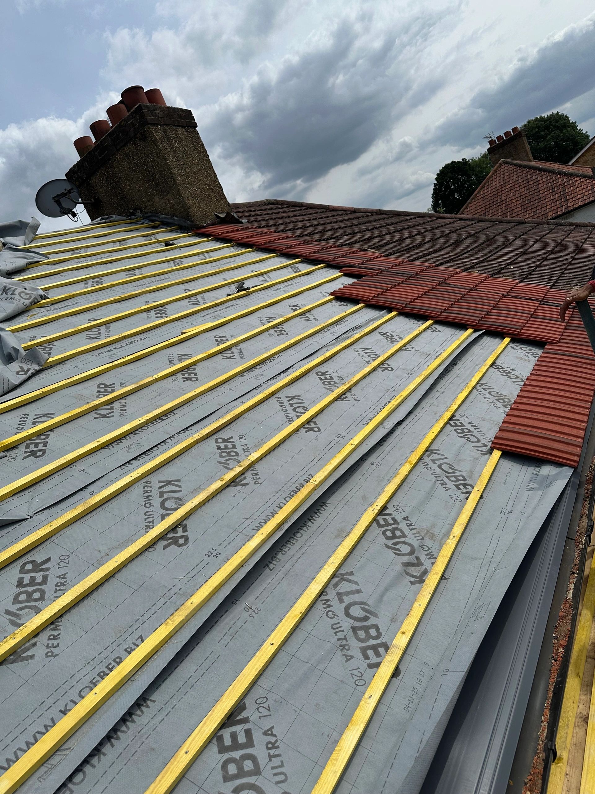 Roof refurbishment in progress with new breathable felt and treated battens, ready for the new tiles to be laid.