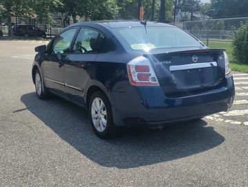 Blue Nissan Sentra parked on a street.