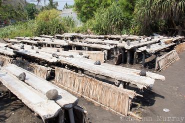 Sea salt dries on elevated racks in Amed, Bali.