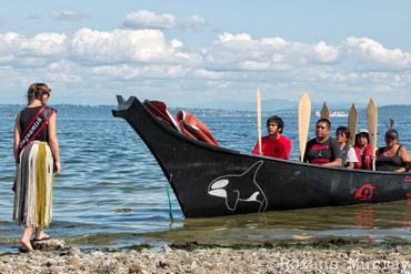 A young girl from the Suquamish Tribe welcomes paddlers during Canoe journey.