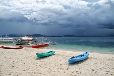 Kayaks sit onshore at Honda Bay, Palawan.