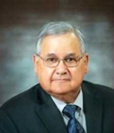 Portrait of an elderly man in a suit and tie.