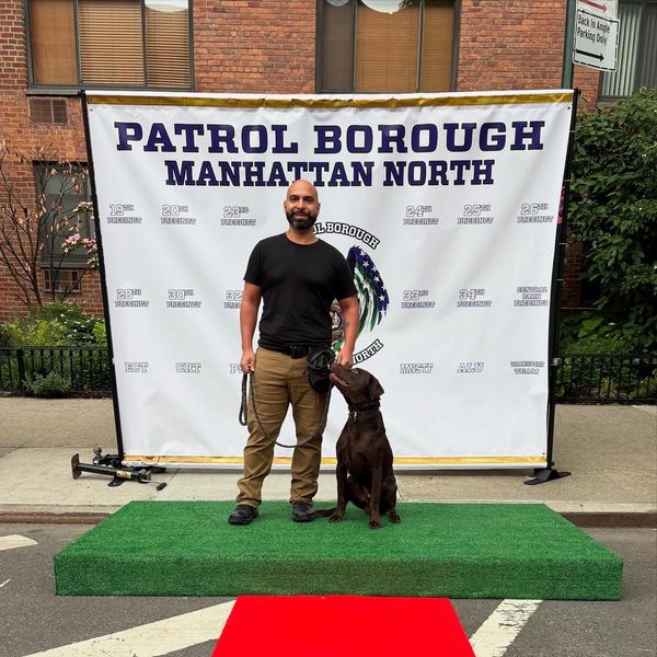 Man with dog at Manhattan North Patrol Borough event.