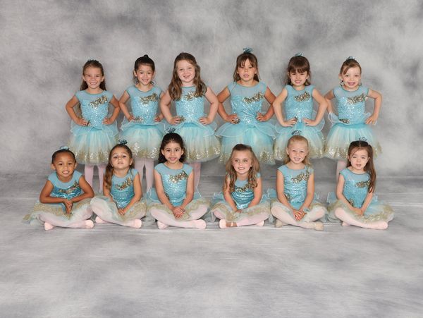 Group of young girls in blue and gold ballet costumes.