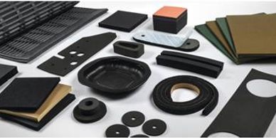 Various black and brown rubber components on a white surface.