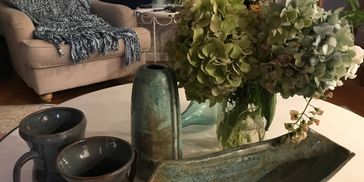 A table full of hand crafted pottery