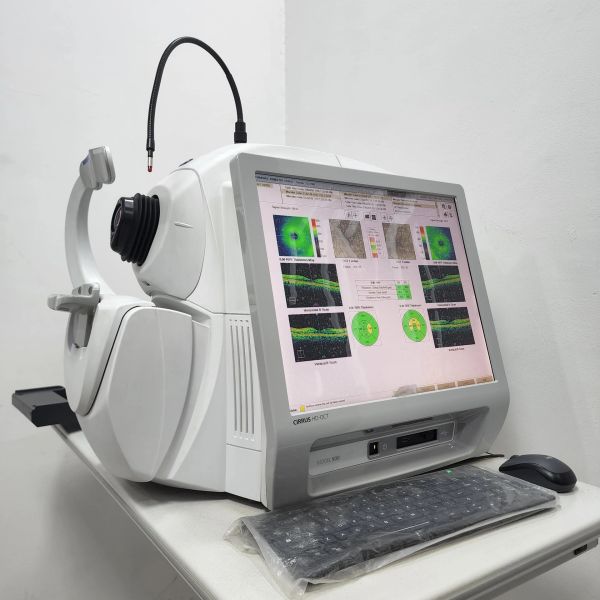 An ophthalmic diagnostic machine with a screen displaying eye scans.