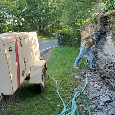 Jackhammer the site in preparation of installing the wall mural.