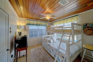 Kids' bunk room with a twin-over-full bunk bed and pull-out twin trundle