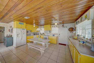 Retro beach kitchen with full-size appliances and ocean-view windows