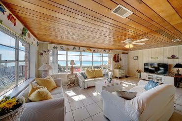 Comfortable retro living room with sofa and beach views, Panama City Beach cottage