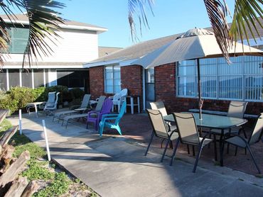 Comfortable outdoor lounge seating facing the Gulf