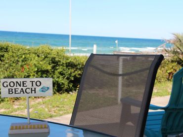 Outdoor patio seating with panoramic views of the sand and water