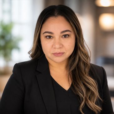 Confident woman with long hair in a black blazer.