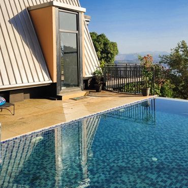 Beautiful infinity pool overlooking the valley and surrounded  by nature