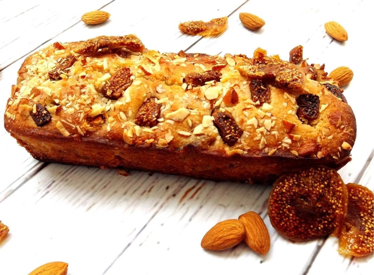Nut and fig loaf cake with almonds around.