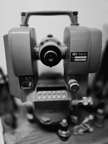 black and white photo of old survey tools