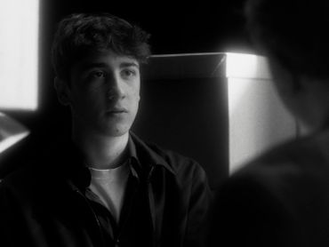 Young man in a black-and-white photo.