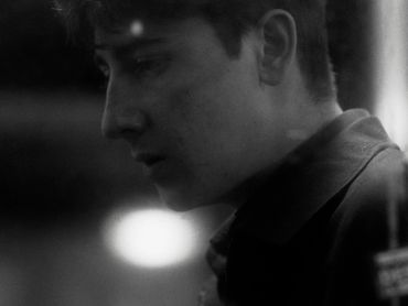 Black and white side profile of a young man.
