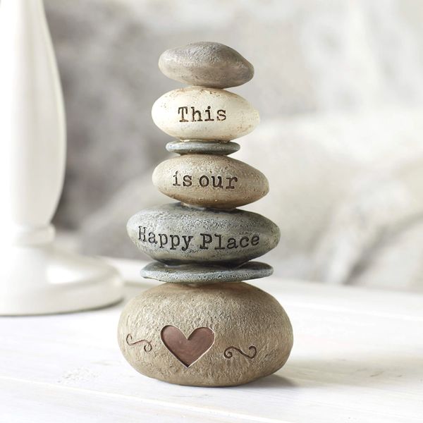 Stacked stones with "This is our Happy Place" text and a heart.
