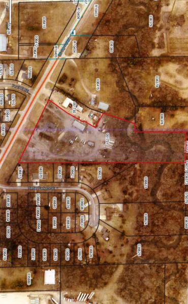 Aerial map showing a large plot outlined in red with surrounding parcels.