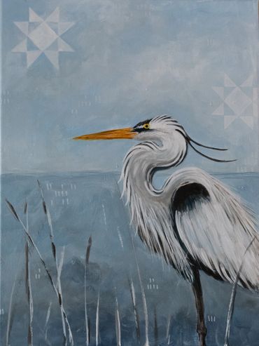 Elegant heron with a long orange beak stands by the water under a cloudy sky.