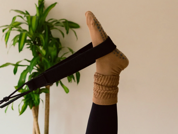 Studio Aligned Reformer Pilates in Monticello NY. Client with feet in straps.