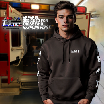 Young man in EMT hoodie in front of ambulance.