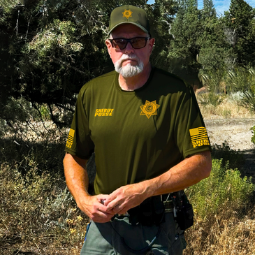 Sheriff Posse officer in uniform outdoors.