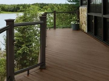 Wooden deck overlooking a serene lake.