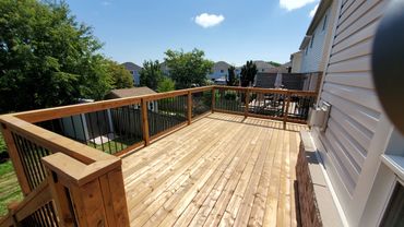 pressure treated deck with wooden railings and aluminum spindles. located in Bowmanville, Ontario.