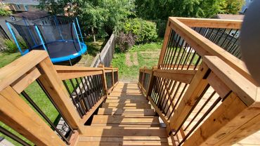 pressure treated deck with wooden railings and aluminum spindles. located in Bowmanville, Ontario.