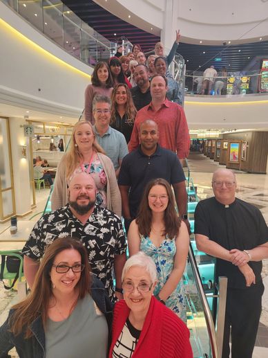 Group of people on an escalator in a mall.