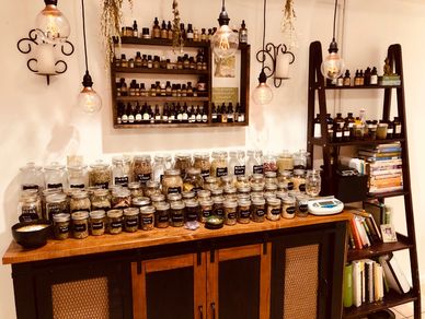 Herbal apothecary with jars of dried herbs, tinctures, and essential oils.